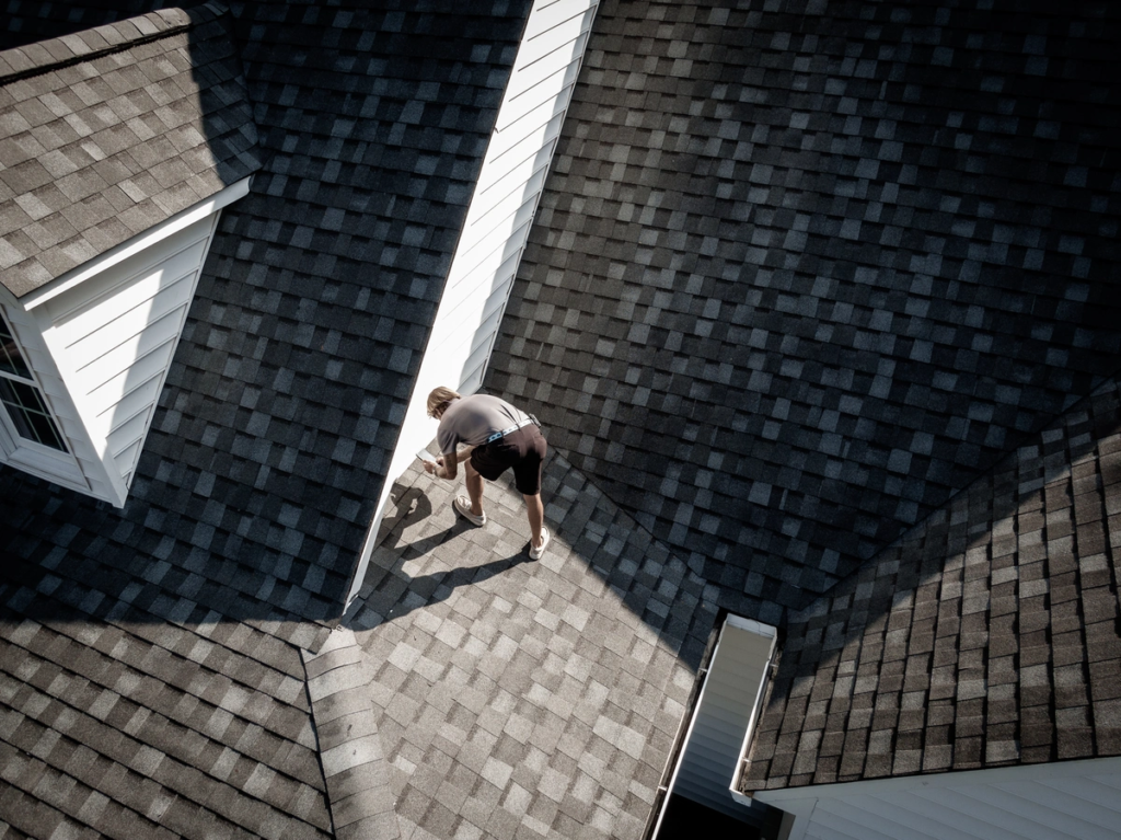 a worker is installing malarkey roofing