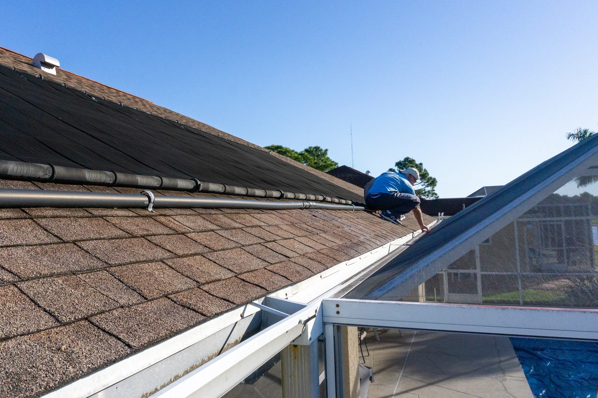 diy roof-man standing on roof making repairs