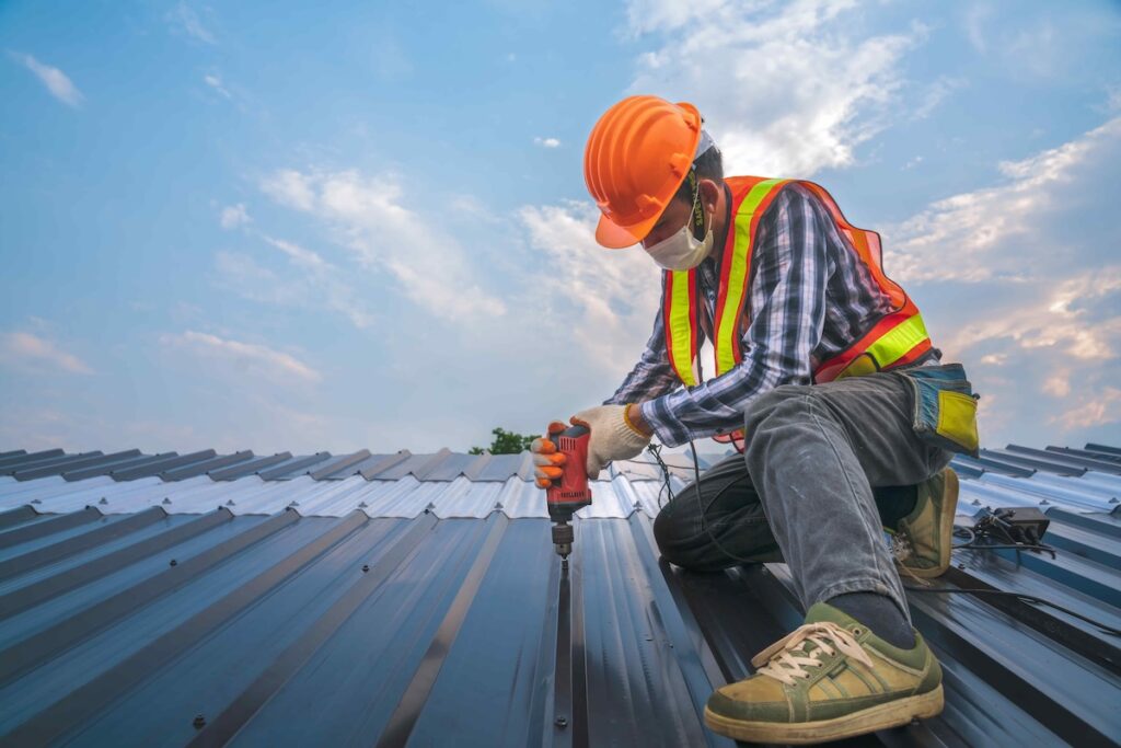 Expertise construction worker wear safety uniform install new metal roofing work for roof ,worker roofer builder working on roof structure on construction site, industrial concept with copy space