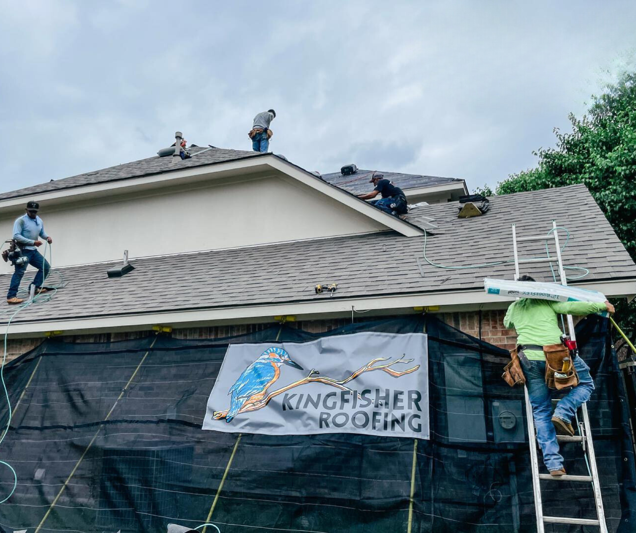 kingfisher roofing contractors working on residential shingle roof replacement